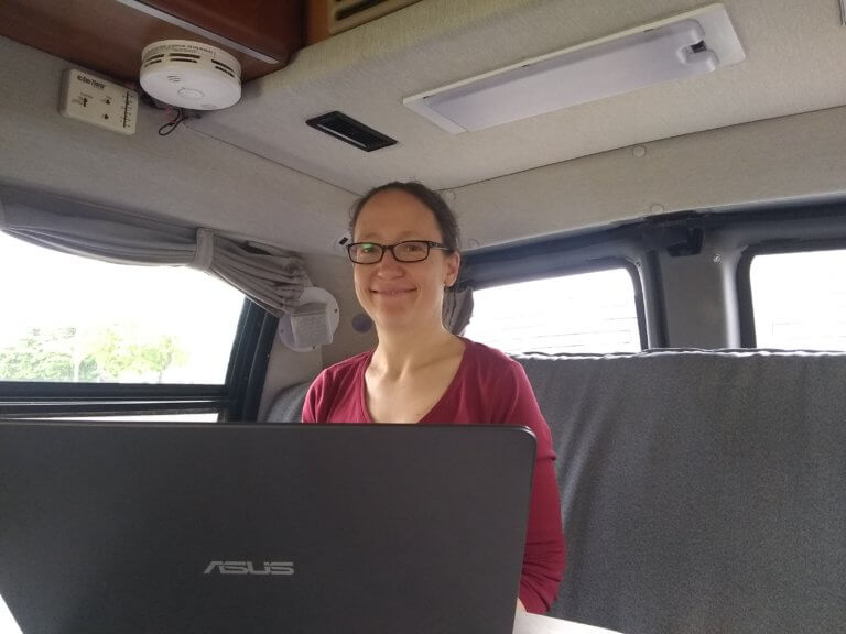 Tehama employee using laptop in an RV