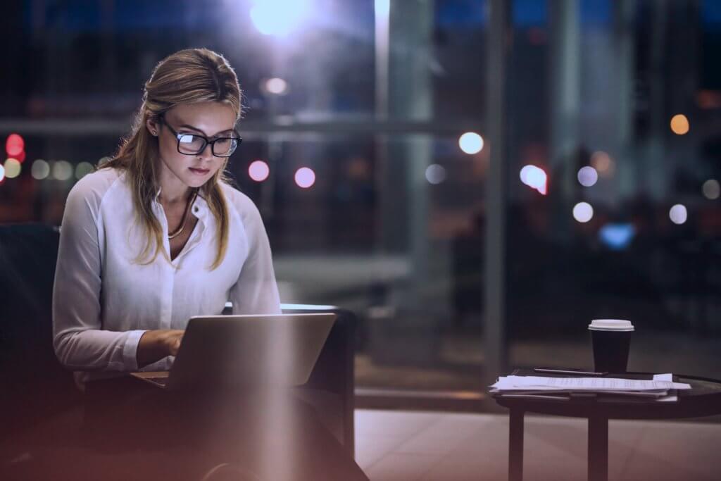 Women using a virtual desktop laptop at night